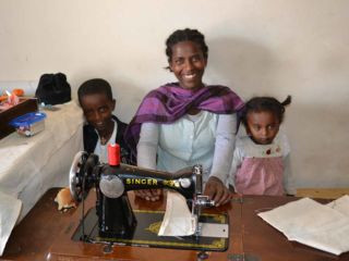 happy-woman-and-children-at-sewing-machine.jpg