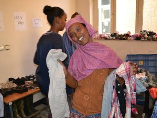 happy-woman-selecting-clothes-at-benefit-souk.jpg