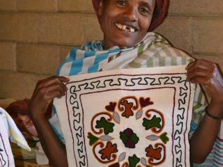 korah-woman-showing-her-embroidery.jpg