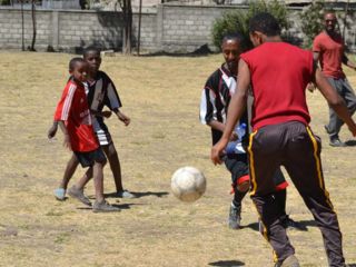 boys-and-adults-playing-soccer.jpg