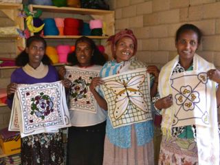 women-holding-up-embroidered-linens.jpg