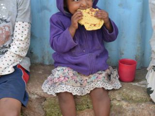 young-girl-taking-bite-of-berta-pancake.jpg